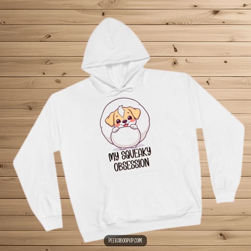 Funny puppy character peeking with delight from behind a giant squeaky toy, printed on a cozy hoodie for ultimate comfort and playful style.