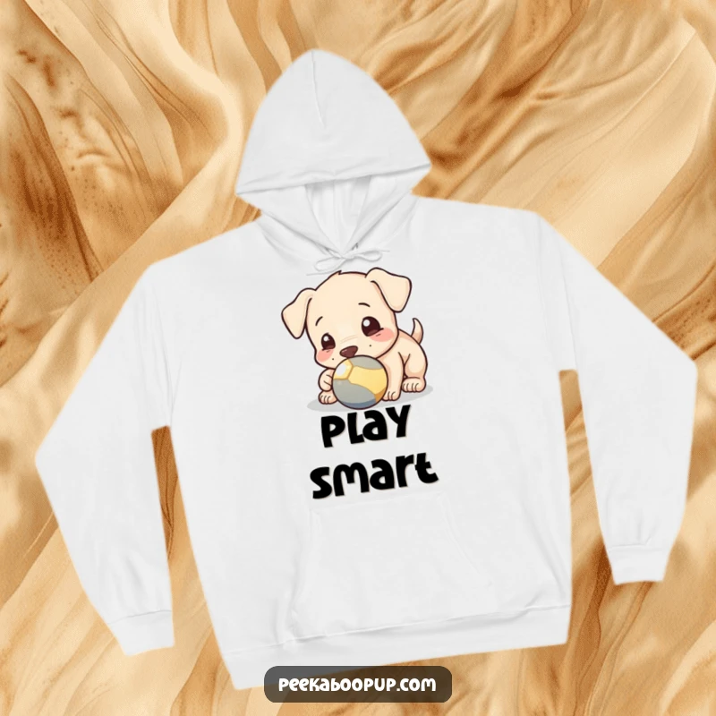 Funny hoodie showcasing a puppy playfully nudging a ball with its nose, offering warmth and a heartwarming visual for dog lovers.