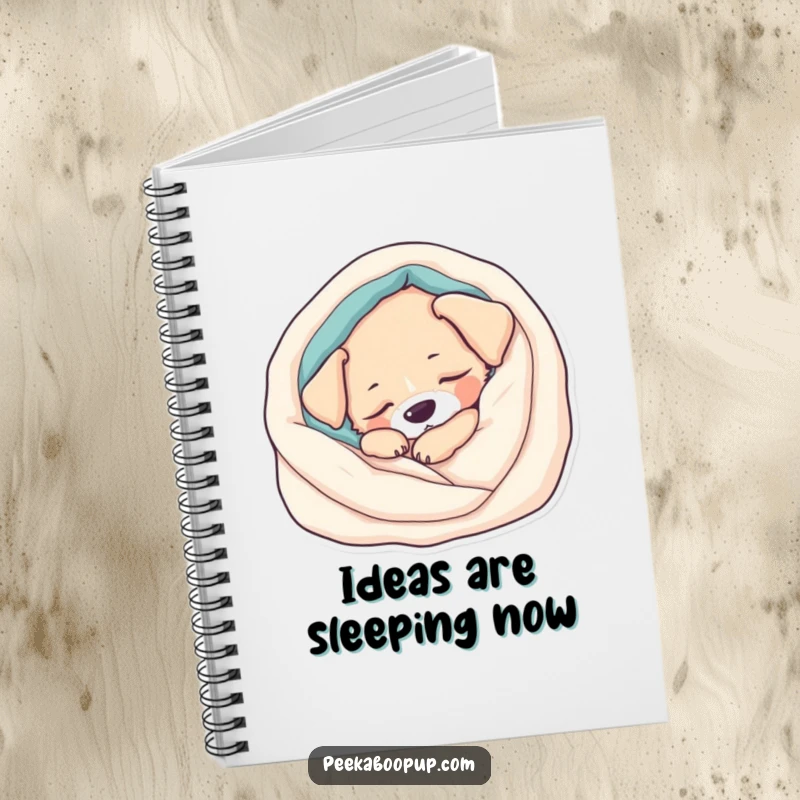 Funny Notebook: A sleepy puppy rests in a soft blanket, perfect for jotting down calm thoughts or sweet dreams. Encourages relaxation.