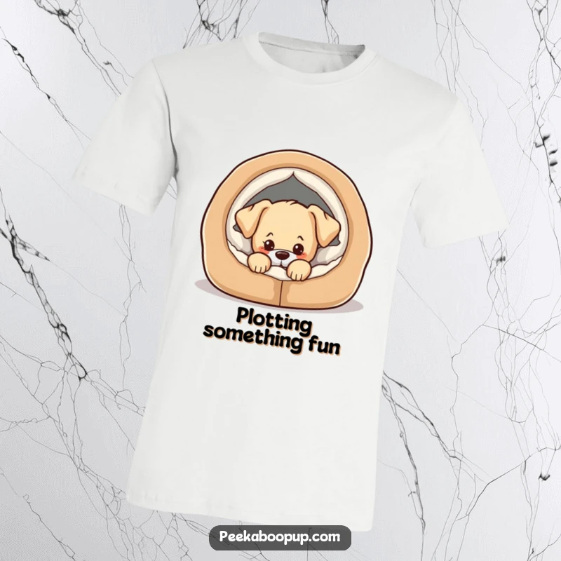 Funny t-shirt print of a cute puppy peeking coyly from a cozy dog bed, hinting at mischief.