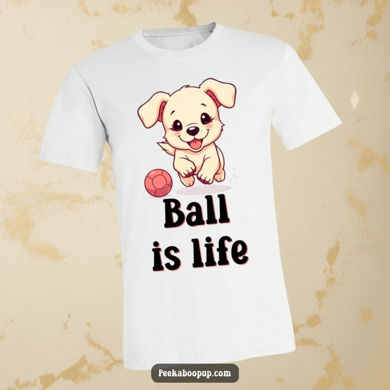 Funny t-shirt graphic of a cute, floppy-eared puppy joyfully running after a bouncing ball, showcasing playful energy and charm.