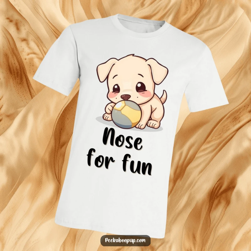 Funny T-shirt depicting a playful puppy nudging a ball with its nose, perfect for dog enthusiasts who love active pups.